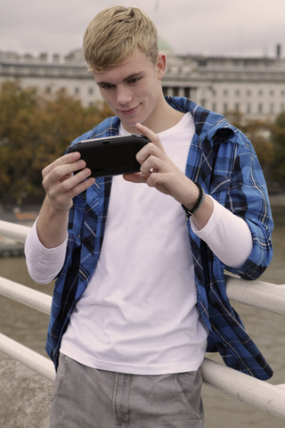 Illustration for article titled Attractive Young Men Smiling at the PlayStation Vita